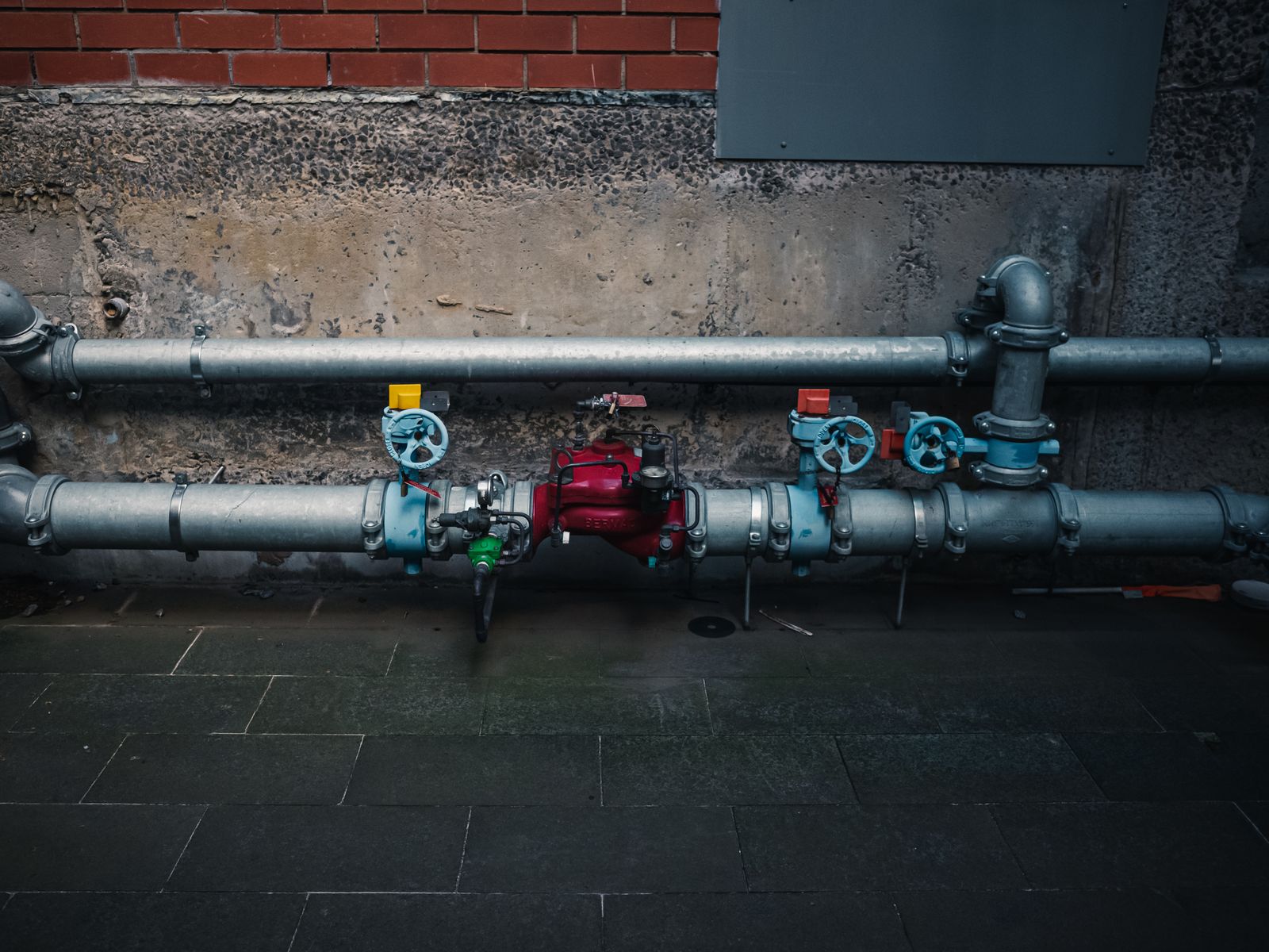 Commercial plumbing and pipework Commercial pipework fitted with isolation valves on a wall